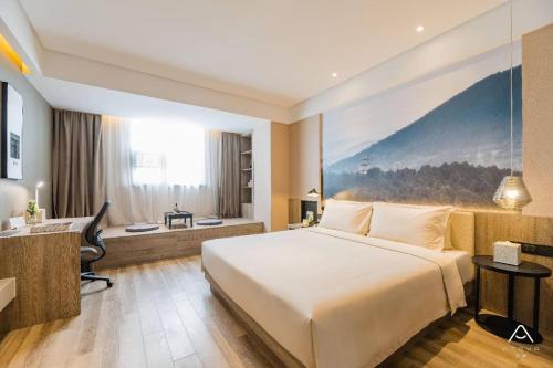 南京Atour Hotel Maqun Nanjing的配有一张床和一张书桌的酒店客房