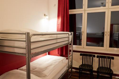 柏林博尔豪斯柏林旅舍的客房内的双层床和两把椅子