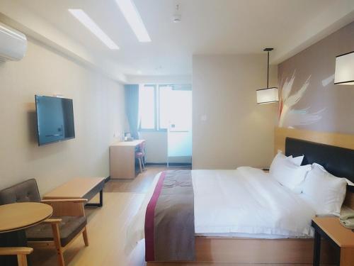 重庆尚客优酒店重庆南岸区同景国际店的一间卧室配有一张床、一张桌子和一台电视。