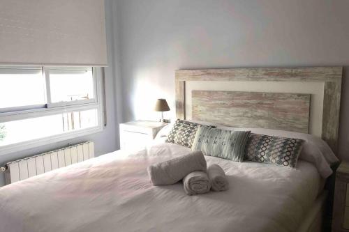 卡隆赫Apartamento Can CALET con PARKING en Sant Antoni de Calonge的卧室配有白色床和毛巾