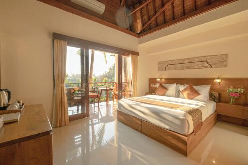 乌布古农梅尔塔简易别墅酒店的一间卧室设有一张床和一个阳台