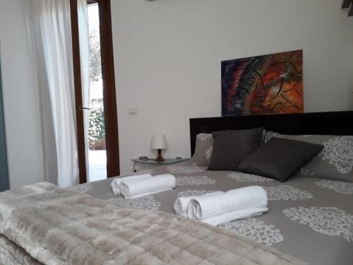 维罗纳Home Scalzi 18的一间卧室配有带毛巾的床