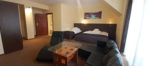 罗兹尤卡酒店的酒店客房,设有两张床和一张沙发