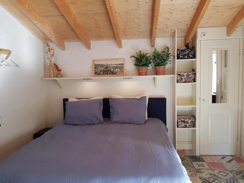 奥德斯希尔德Stella Maris的一间卧室配有一张带紫色枕头的床