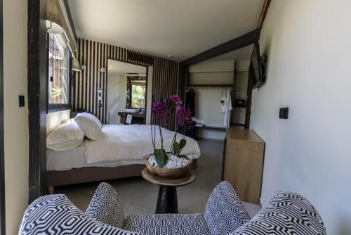 萨阿拉德洛斯阿图内斯Hotel Boutique Varadero的一间卧室配有一张床和一张桌子及椅子