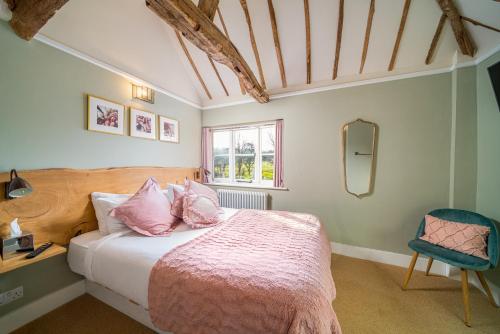 大米森登纳格斯海德酒店的一间卧室配有带粉红色枕头的床和窗户。