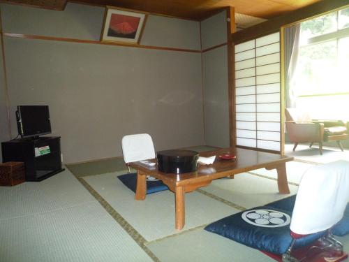 京都高尾山观光酒店的客厅配有桌椅