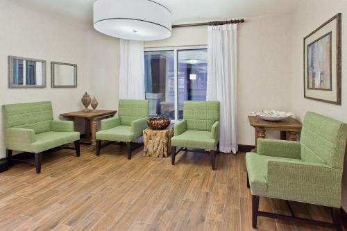 亨茨维尔亨茨维尔西-研究园智选假日酒店的客厅配有绿色椅子和桌子