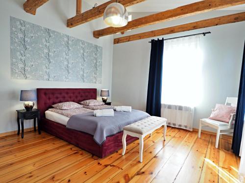 索波特Berni's home Apartament z tarasem的一间卧室设有一张大床,铺有木地板
