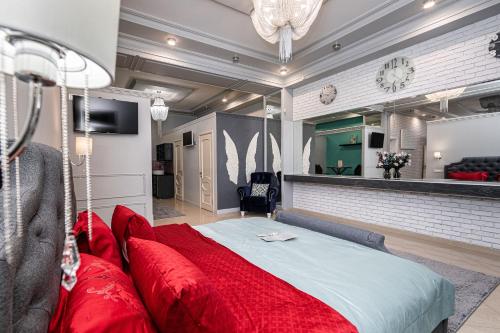 马哈奇卡拉Krepost Mini Hotel的一间卧室配有一张带红色枕头的大床