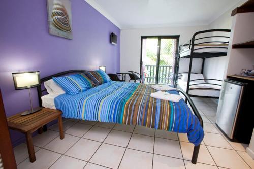 凯恩斯凯恩斯波希米亚度假村的一间卧室配有一张床和一张双层床。