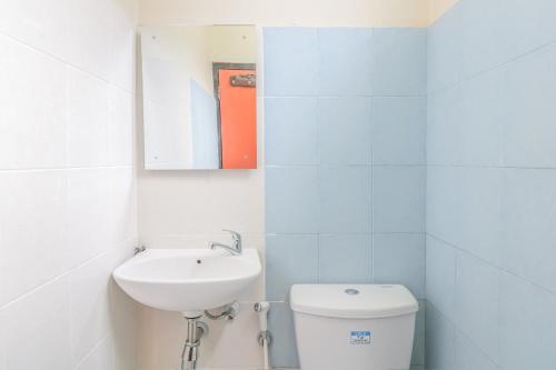 登巴萨Catur Adi Putra的白色的浴室设有水槽和卫生间。