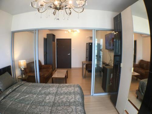 曼谷Supalai Rama9 Monthly的一间卧室设有一张床和一间客厅。