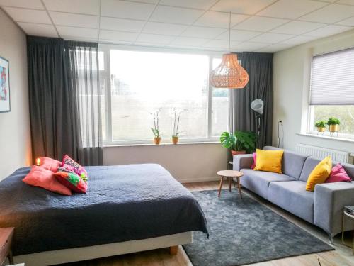霍赫芬Studio Brinkstraat的一间卧室配有一张床和一张沙发