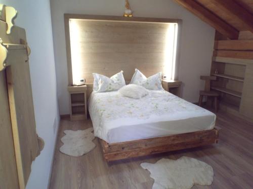 圣斯特凡诺迪凯德B&B antico tabià dolomitico的一间卧室配有带白色床单和枕头的床。