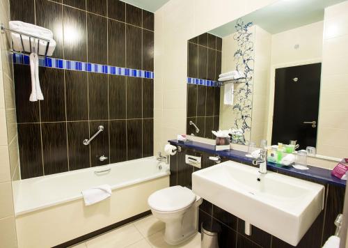 布兰察斯镇都柏林皇冠假日酒店布兰查的浴室配有盥洗盆、卫生间和浴缸。