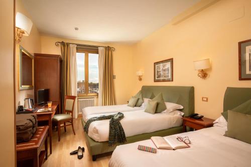 罗马圆形大剧场酒店的酒店客房配有两张床和一张书桌