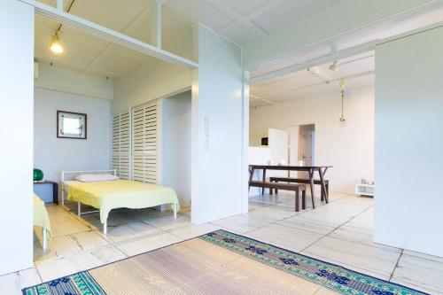 石垣岛amber moon的客厅配有床和桌子