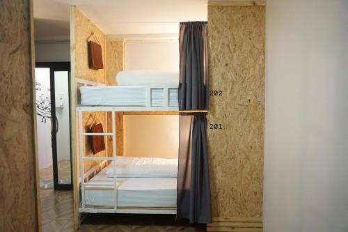 合艾Khoksametchun Hostel的客房设有带白色床铺的双层床。