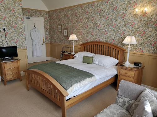 阿尼克Greycroft B&B的卧室配有一张床和墙上的一套西装