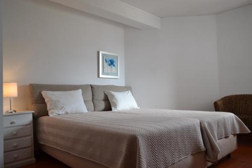 维拉摩拉加尔维图阿尔伽迪亚滨海公园公寓的一间卧室配有一张床和一个带床罩的床头柜