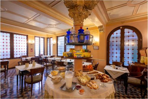 威尼斯马可尼酒店的用餐室配有餐桌和食物