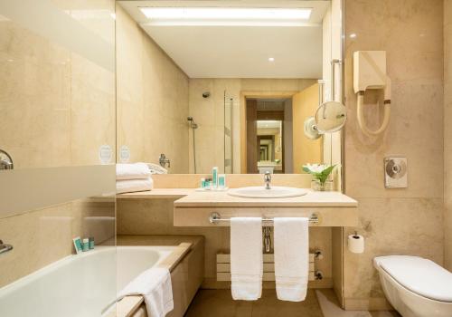 马德里伊鲁尼皮奥12号酒店的一间带水槽、浴缸和卫生间的浴室