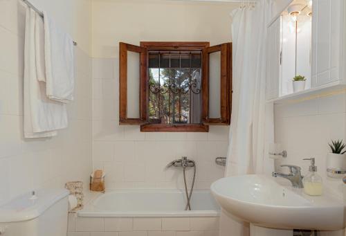 VagiaMarina's Paradise Summer House的白色的浴室设有浴缸、水槽和浴缸。