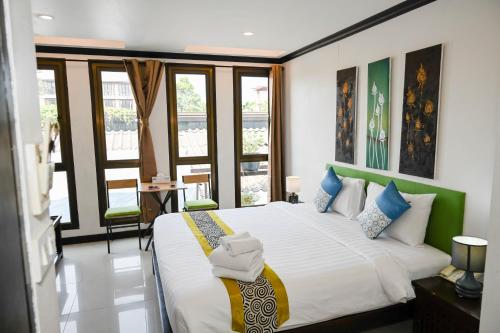 查汶女王精品酒店的一间卧室配有一张大床和毛巾