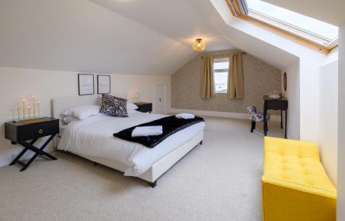赖德Luxury Living, Stylish Modern Apartment in the Heart of Ryde的一间卧室配有一张大床和一张黄色椅子