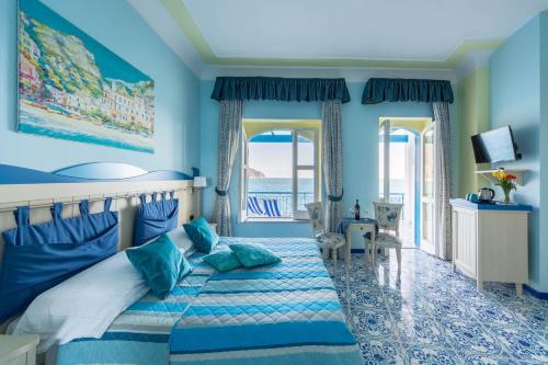 拉维罗圣迈克尔别墅酒店的一间蓝色卧室,配有一张床和一个阳台
