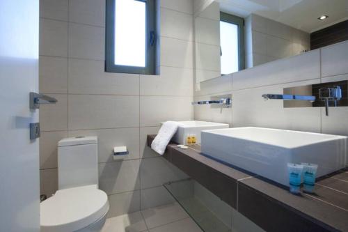 雅典Voula, A modern, minimal and stylish, apartment的白色的浴室设有卫生间和水槽。
