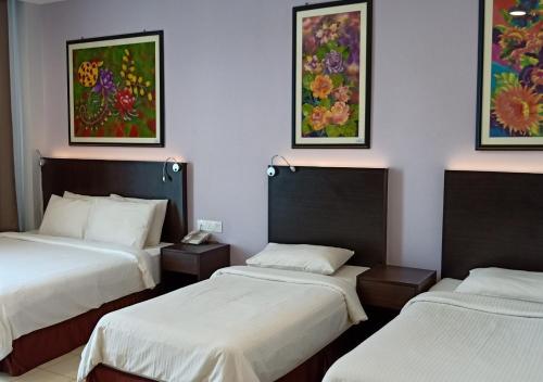 迪沙鲁槟纳瓦尔酒店客房内的一张或多张床位