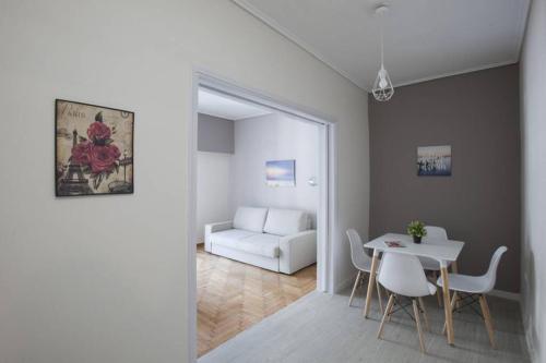雅典Zan Moreas, A simple & minimal apartment的客厅配有桌椅和沙发