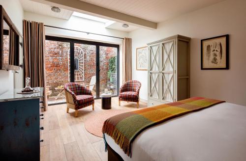 谢伯恩The Eastbury & Spa的一间卧室配有床、椅子和窗户