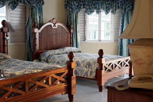 尼格瑞尔巨浪俱乐部度假村的一间卧室配有2张蓝色窗帘
