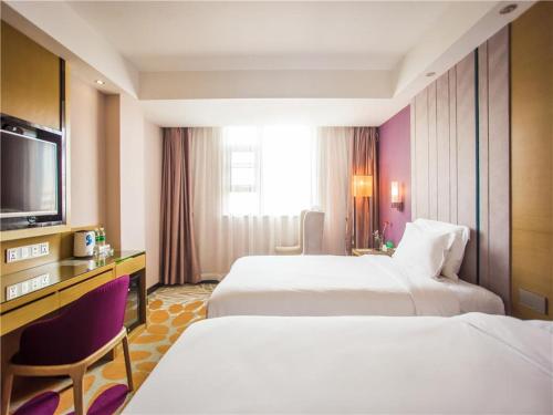 麗枫酒店·湛江国贸广百店客房内的一张或多张床位