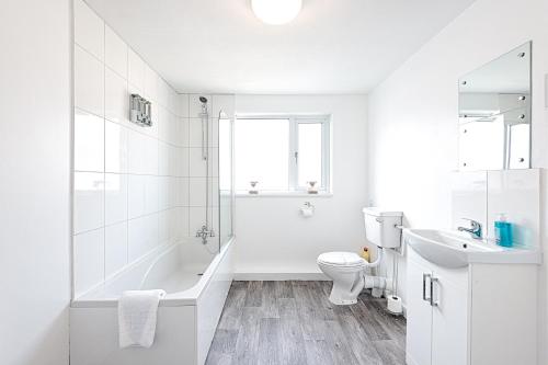 斯旺西The Place to Yourself - Swansea City的白色的浴室设有浴缸、卫生间和水槽。