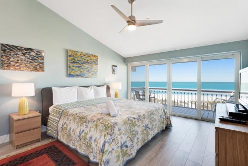 霍姆斯海滩Hidden Cove Unit 6的一间卧室设有一张床和一个海景阳台