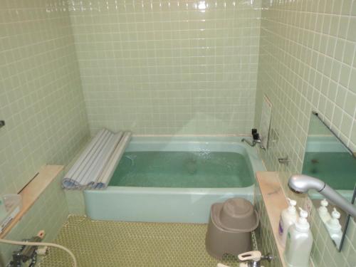 白马村马利翁奈特旅馆的瓷砖浴室设有浴缸。