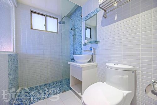 马公华馨大饭店的浴室配有白色卫生间和盥洗盆。