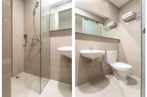 棉兰Super OYO 3159 Festive Inn的带淋浴、卫生间和盥洗盆的浴室