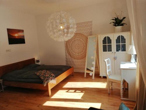 瓦尔斯Privé sauna & terras - Aachen Vaals Drielandenpunt的一间卧室配有一张床和一个吊灯