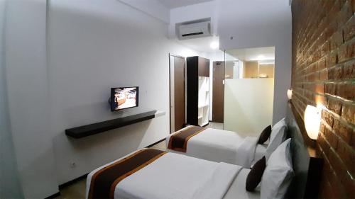 明古鲁艾科斯塔酒店客房内的一张或多张床位