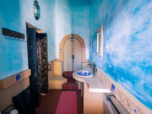 莫桑比克岛Terraço das Quitandas Design Accommodation-AL的一间带水槽和蓝色墙壁的浴室