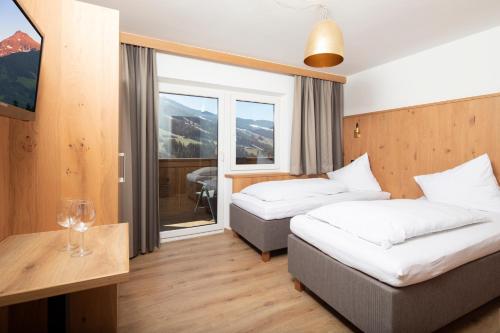 阿尔卑巴赫安德里亚斯酒店的酒店客房设有两张床和窗户。