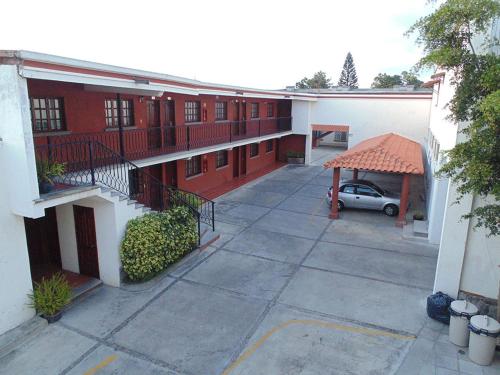 古斯曼城Hotel Hacienda的庭院里设有停车位的公寓楼