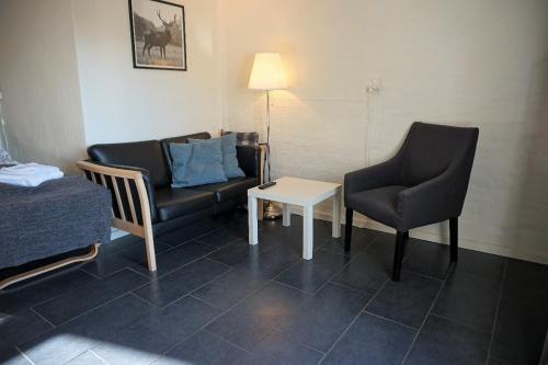 凯特明讷Kerteminde Byferie - Hyrdevej 83, 85K的一间配有沙发、两把椅子和一张桌子的房间