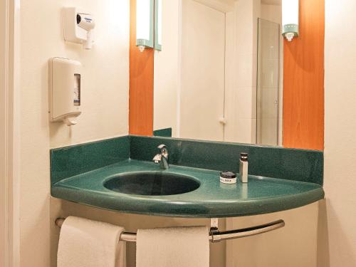 蒙特雷蒙特雷谷宜必思酒店的一间带绿色水槽和镜子的浴室