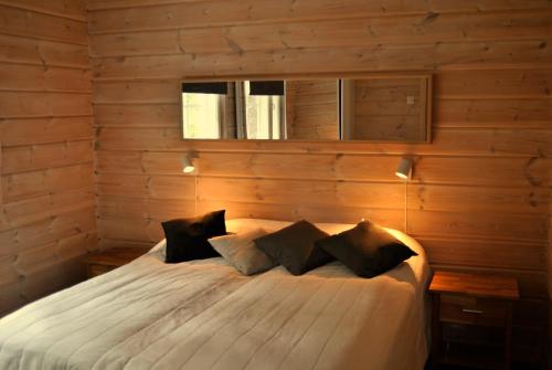 鲁卡RukaNeliö Cottage的一间卧室配有一张木墙床